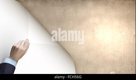 Human hand turning white blank paper page Stock Photo