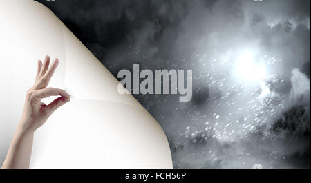 Human hand turning white blank paper page Stock Photo