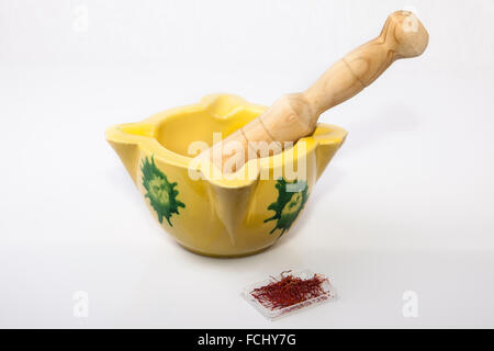 Clay mortar with spanish saffron Isolated on white background Stock Photo
