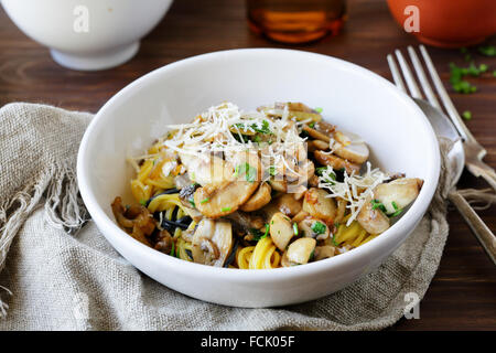pasta with fried mushrooms and cheese in bowl Stock Photo