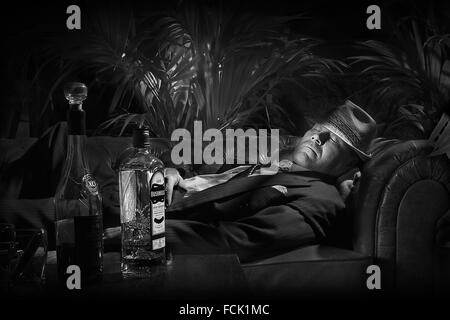 Scary-looking bad guy in hat, sleeping, film noir style Stock Photo