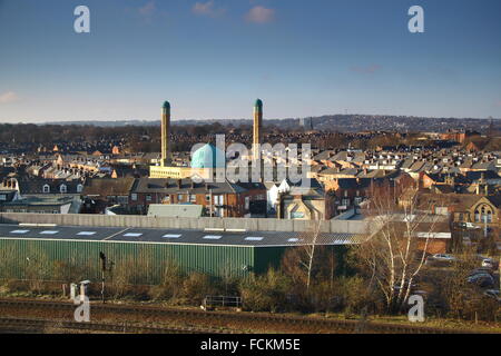 Skyline of Sheffield looking to the main rail line into the city, blue dome of the Madina Masjid mosque and hills beyond Stock Photo