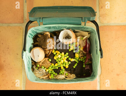 food waste - indoor food recycling caddy full of kitchen waste for recycling or composting Stock Photo