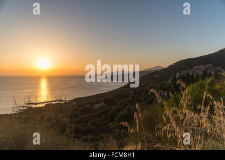 Sunset over olive trees, villages and forests of the coastline near Pisciotta in Cilento in southern Italy Stock Photo