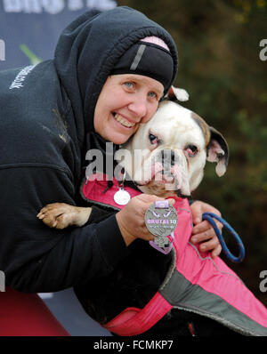 Aldershot, Hants, UK. 23rd January, 2016. Jools and Phoebe Pocknell celebrate with their medal after completing the 5KM canicross Brutal women  race at Long valley Aldershot Hampshire.  The recent weather made the Brutal 10km off road course live up to its name as the puddles and streams where up to waste height in many places with early runners having to break the ice as they entered the water.  Credit:  PBWPIX/Alamy Live News Stock Photo