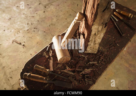 High angle view of artist tools, chisel and hammer for wood sculpture on desk. Stock Photo