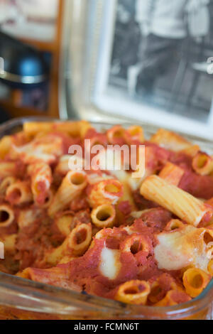 baked pasta with mozzarella salami eggs tomato sauce and cured ham Stock Photo