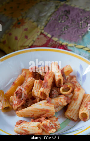 baked pasta with mozzarella salami eggs tomato sauce and cured ham Stock Photo