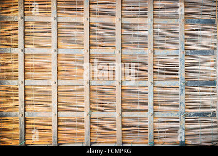 Window with a straw mat and metal bars Stock Photo