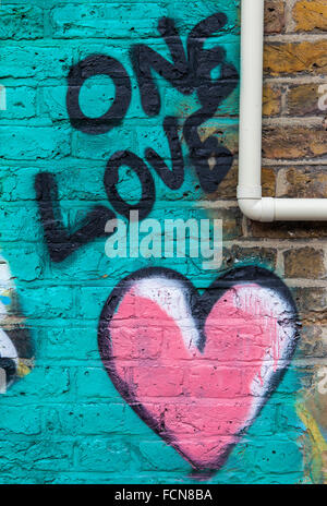 LONDON, UK - JANUARY 13TH 2016: An abstract piece of graffiti on a brick wall symbolising love, on 13th January 2016. Stock Photo