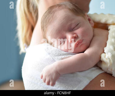 Mother holding sleeping newborn child Stock Photo