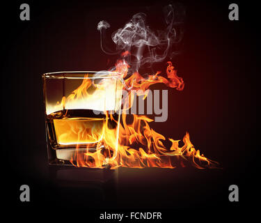 Image of glass of burning yellow absinthe Stock Photo