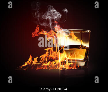 Image of glass of burning yellow absinthe Stock Photo