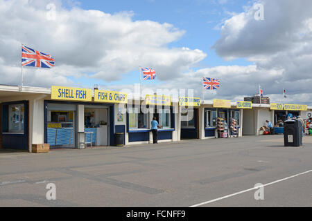 Seafront promenade shops and food outlets at Littlehampton, West Sussex, England. With people and British flags flying. Stock Photo