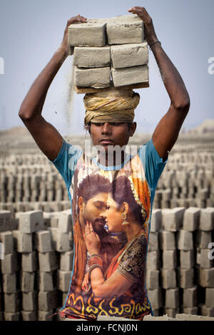 Dhaka, Dhaka, Bangladesh. 18th Jan, 2016. 18 January 2016, Dhaka Bangladesh - A young boy work in a brickfield covered with thick dust. In this brickfield burning coal produce Carbon-Di-Oxide (CO2) gas, which is primarily responsible for climate change. Beside this the working condition is so dusty that time they cannot breathe properly. About 11,000 brickfields are established across Bangladesh to meet the growing demand of construction works as urbanization rises rapidly in the country. © K M Asad/ZUMA Wire/Alamy Live News Stock Photo