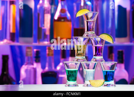 Pyramid of shot glasses with drinks and lime Stock Photo