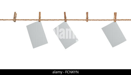 grey photo paper. Hanging on a clothesline with clothespins. On  white background Stock Photo