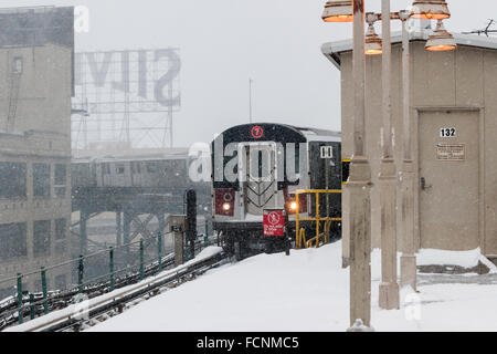 New York, USA. 23rd Jan, 2016. An elevated Flushing Line train arrives at the Queensboro Plaza station in New York during Winter Storm Jonas on Saturday, January 23, 2016. Due to blizzard conditions approaching the MTA announced they will be suspending all above ground subway service as of 4:00 PM. Credit:  Richard Levine/Alamy Live News Stock Photo