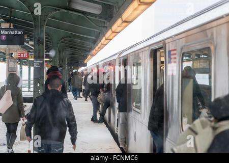 New York, USA. 23rd Jan, 2016. Passengers enter and depart a Flushing Line train in the Queensboro Plaza station in New York during Winter Storm Jonas on Saturday, January 23, 2016. Due to blizzard conditions approaching the MTA announced they will be suspending all above ground subway service as of 4:00 PM. Credit:  Richard Levine/Alamy Live News Stock Photo