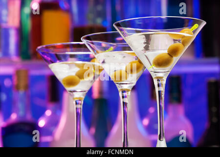 Several cocktail glasses with olives in the bar Stock Photo