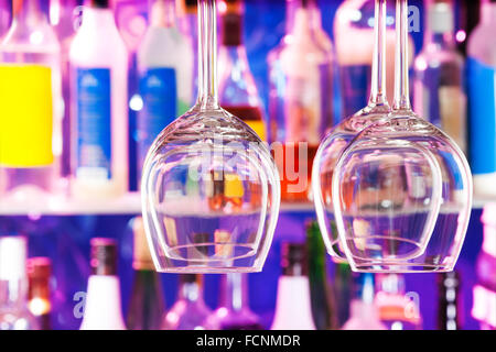 Some wine glasses on hanger in bar Stock Photo
