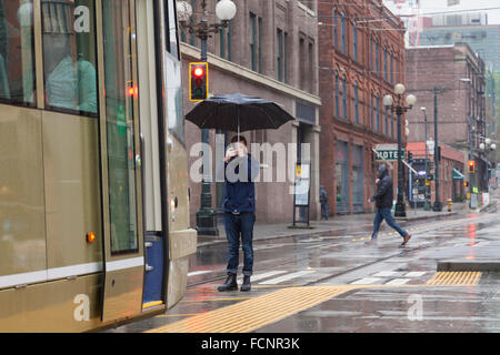 Seattle, USA. 23rd Jan, 2016. Young man taking a photo of a Streetcar at the Occidental Mall Station during the Seattle Streetcar First Hill Line inaugural run on January 23, 2016. The First Hill Streetcar is a 4 kilometer-long line that connects Pioneer Square and Capitol Hill via the International District, Yesler Terrace, and First Hill. It is the second line implemented after the South Lake Union Streetcar opened in 2007. Credit:  Paul Gordon/Alamy Live News Stock Photo