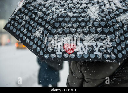 New York, USA. 23rd Jan, 2016. Woman carrying I Love New York / I Heart NY umbrella to shied her face from strong winds and snow in Midtown Manhattan, New York City during blizzard storm Jonas. January 23, 2016. Credit:  Brigette Supernova / Outer Focus Photos/Alamy Live News Stock Photo