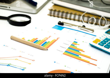 Laptop on Desk office and Graph analysis spreadsheet Stock Photo