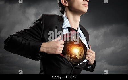 Businessman opening his shirt on chest acting like super hero Stock Photo