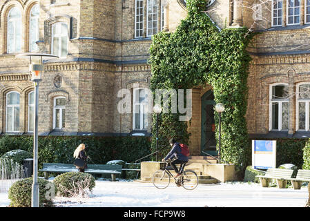 Lund, Sweden - January 21, 2016: The entrance to the house Gamla kirurgen at Lund university. It is winter and two persons are s Stock Photo