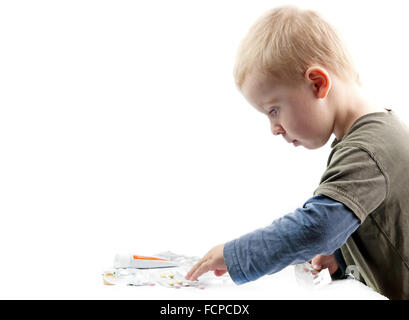 boy plays pills. Isolated on white Stock Photo