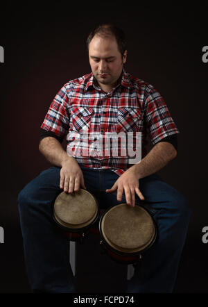 portrait of musician with bongo , studio shot Stock Photo