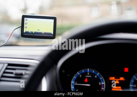 A 'tomtom' satellite navigation system (sat nav) or GPS set up in a car. Stock Photo