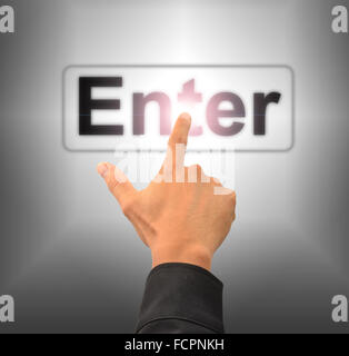 finger push enter button on touch screen interface Stock Photo