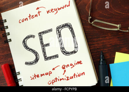 Words SEO (search engine optimization) written in the notepad. Stock Photo