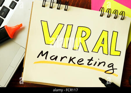 Notepad with viral marketing on the wooden table. Stock Photo