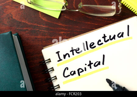 Notepad with Intellectual capital on the wooden table. Stock Photo
