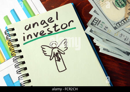 Notebook with angel investor  sign.  Business concept. Stock Photo