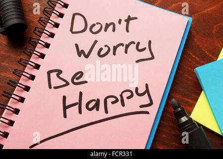 Notebook with the words Don’t worry Be happy  on the table. Stock Photo