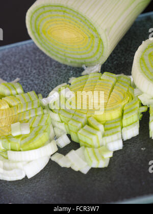 Slices of leek on a glass plate in a kitchen Stock Photo