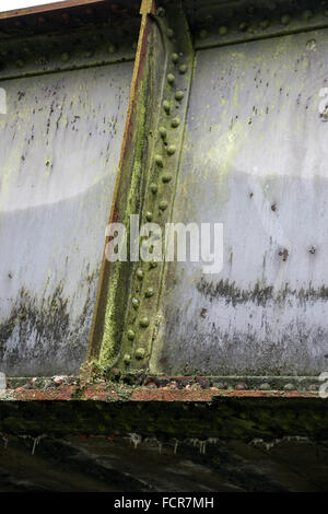 Rusty metal on an old railway bridge over the Macclesfield Canal Stock Photo