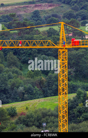 yellow construction crane on a background of blue sky Stock Photo - Alamy