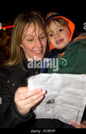 Mother & child attending the local community's christmas carol singing service 2015, Hindhead, Surrey, UK. Stock Photo