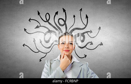 Young pensive businesswoman and thoughts coming out of her head Stock Photo