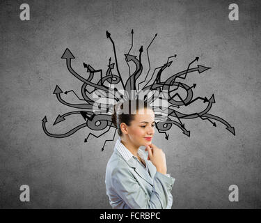 Young pensive businesswoman and thoughts coming out of her head Stock Photo