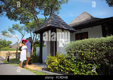 Young attractive couple standing by their villa Stock Photo