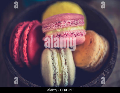 Sweet colorful macaroons cookies in wooden bowl,selective focus on the front Stock Photo