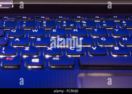A macro closeup of a backlit QWERTY keyboard on a laptop Stock Photo
