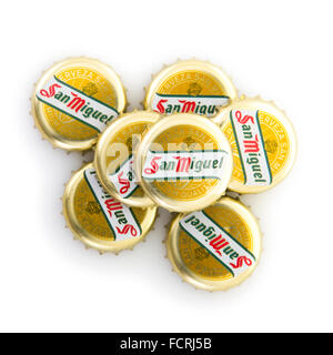 San Miguel beer bottle caps on white background Stock Photo