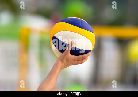 Volleyball is a volleyball being held up by a volleyball player ready to be served. Stock Photo